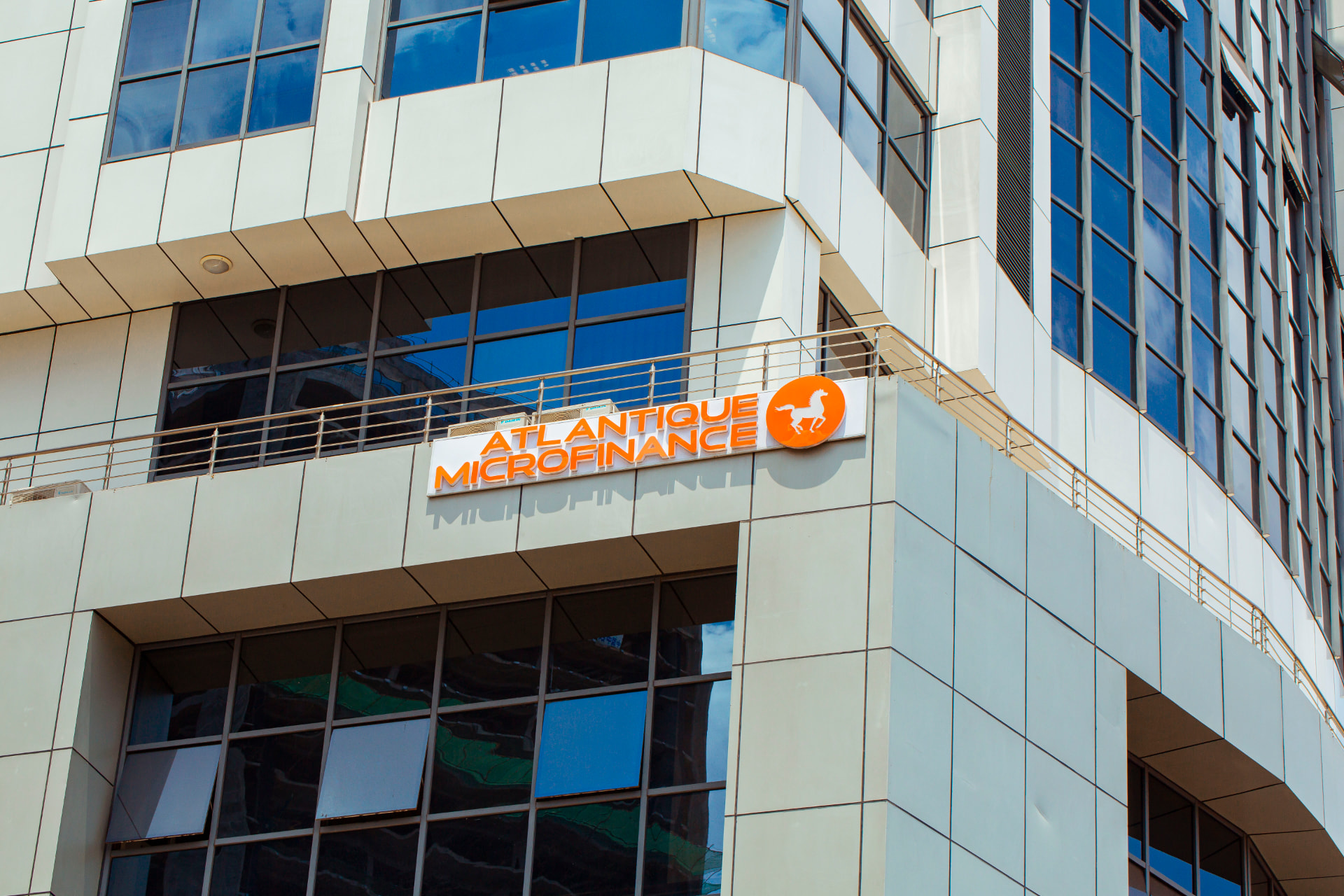 Atlantique Microfinance signage on the YYUSSA City Center building