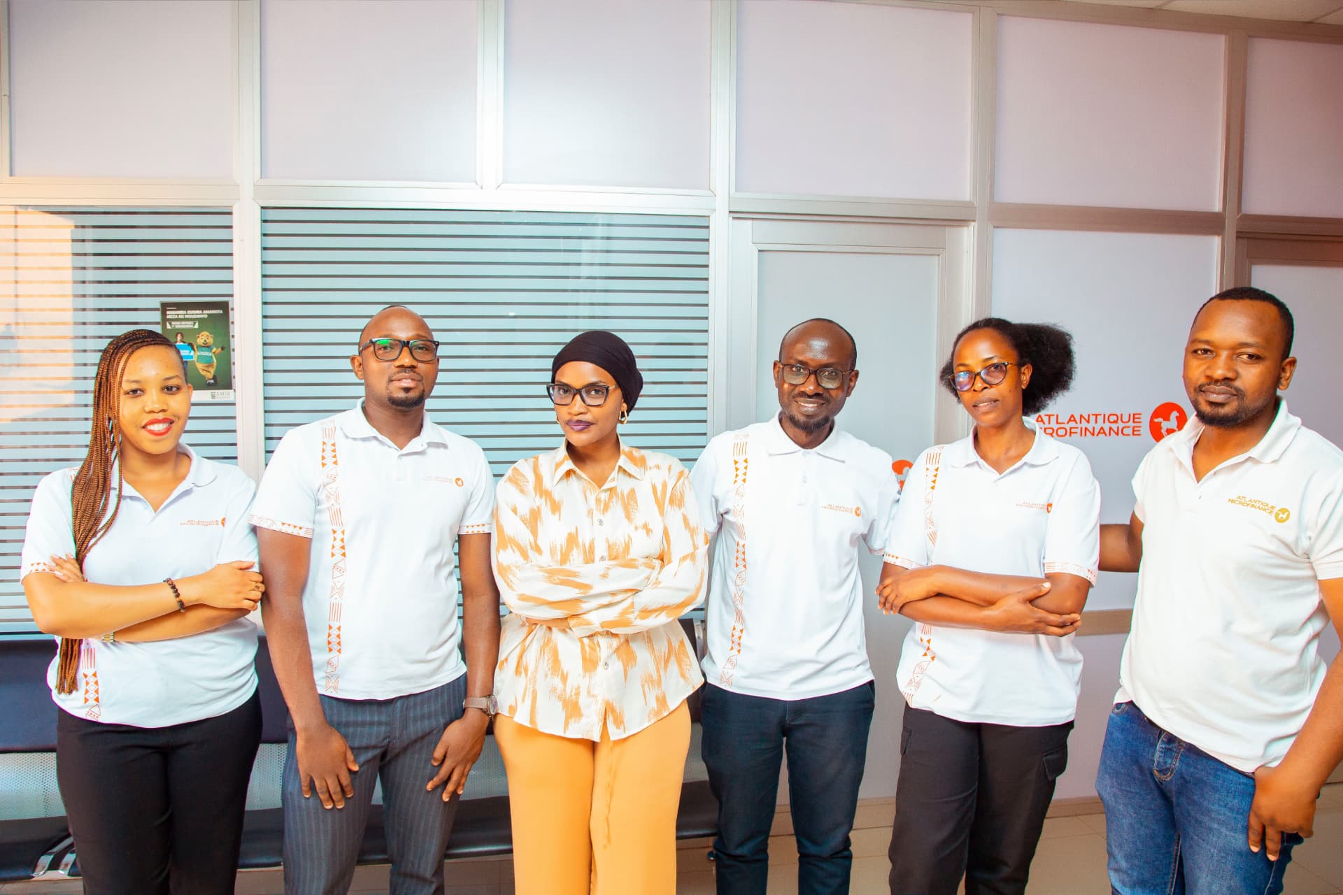 Atlantique Microfinance team outside their office entrance